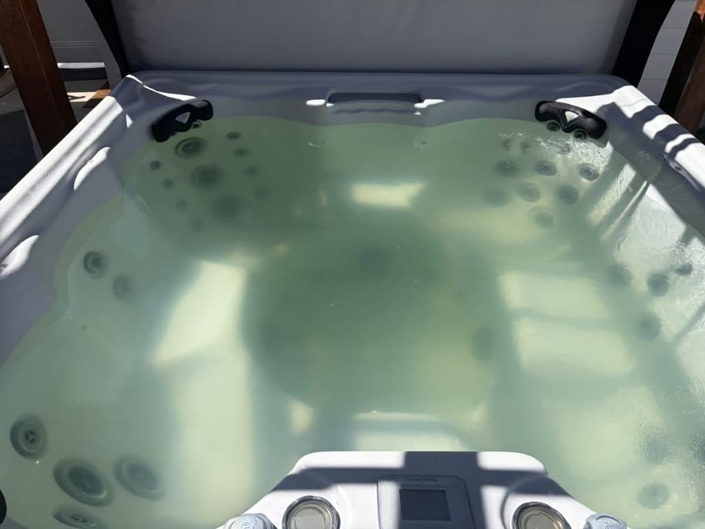 Before: cloudy, discolored hot tub water on a client's spa before Quality Spa Care service